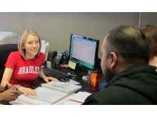 Lorraine working with work study students in a university marketing program